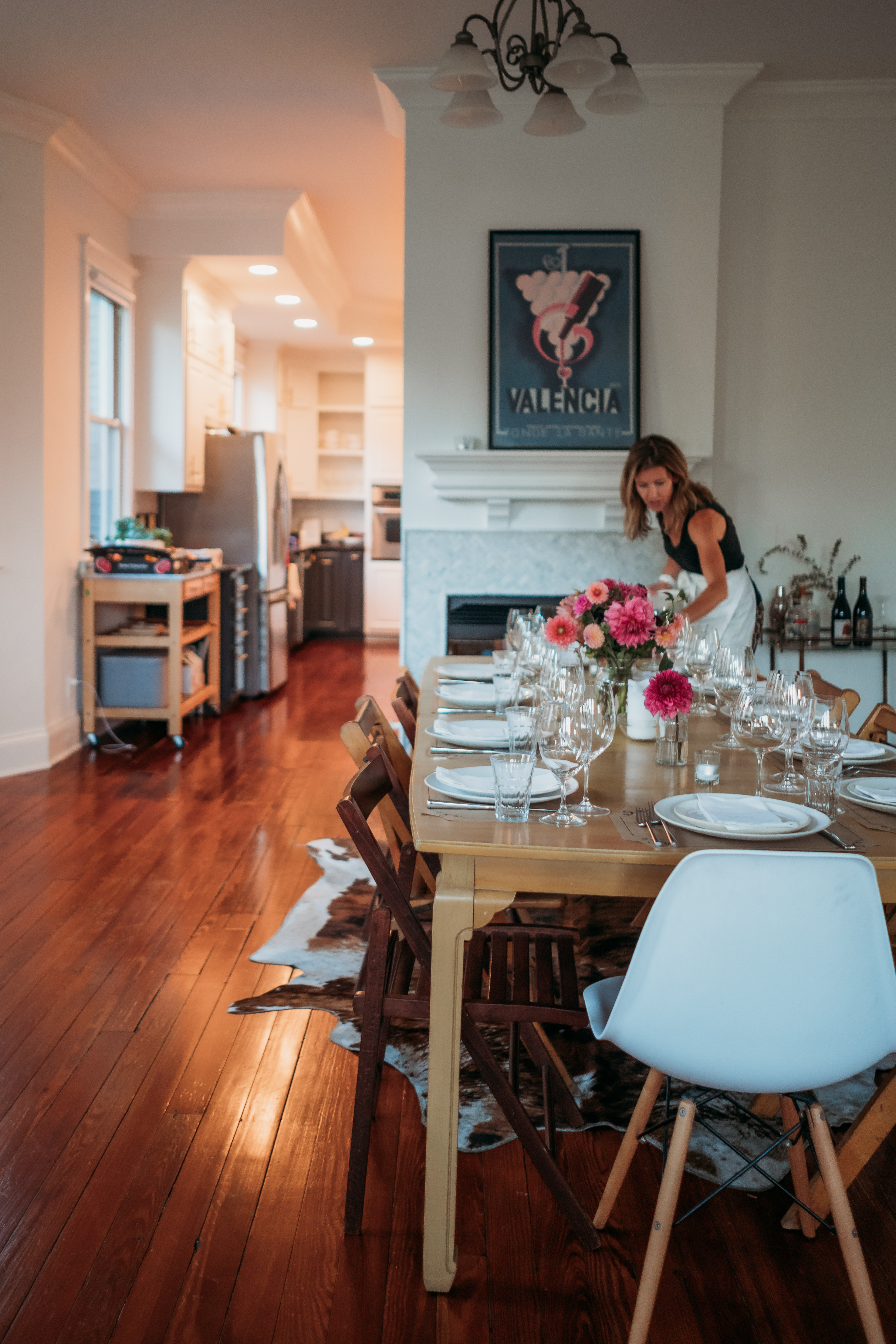 Anna setting a dinner table